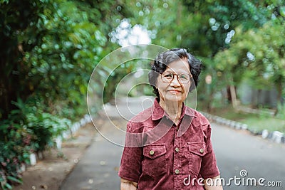 Smiling grandma with eyes glasses walking Stock Photo