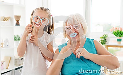 Smiling grandma having fun with granddaughter Stock Photo