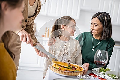 Smiling grandma hugging child near thanksgiving Stock Photo