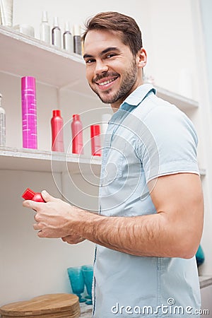 Smiling hairdresser with hair products Stock Photo