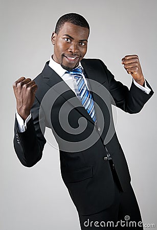 Smiling handsome businessman showing his strength Stock Photo