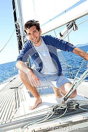 Smiling handsome man enjoying sailing Stock Photo