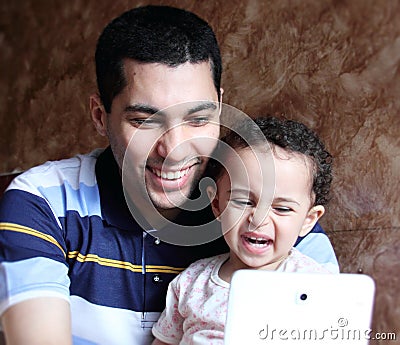 Smiling happy arab egyptian father with daughter taking selfie Stock Photo