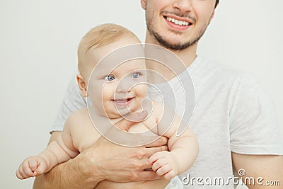 Smiling happy baby in father`s hand. Little enfant toddler Stock Photo
