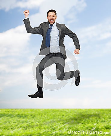 Smiling happy businessman jumping Stock Photo