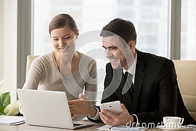 Smiling happy businesspeople using smart devices for mobile busi Stock Photo