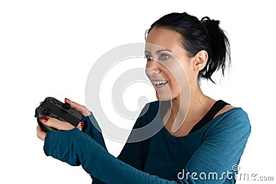 A smiling happy, concentrated young caucasian woman holding a wireless joypad excited focusing playing a digital online video game Stock Photo