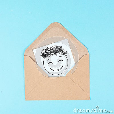 Smiling happy face on a paper inside an evelope, positive emotions, good customer feedback, greeting card Stock Photo