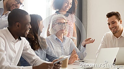 Smiling happy multicultural office employees colleagues laughing together Stock Photo