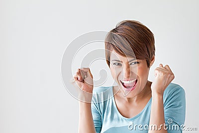 Smiling, happy, positive, excited woman on plain background Stock Photo