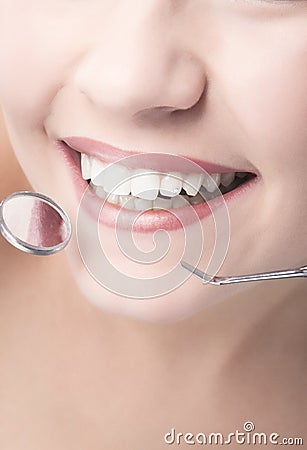 Smiling Healthy Woman Mouth Closeup With Dentist Mirror and Spat Stock Photo