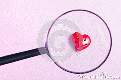 smiling heart on a hightech background and magnifier Stock Photo