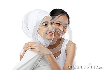 Smiling hijab girl and young girl bestfriend in front of camera Stock Photo