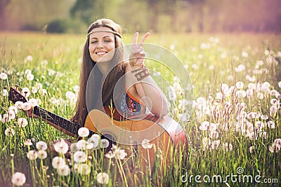 Smiling hippie woman giving peace sign Stock Photo