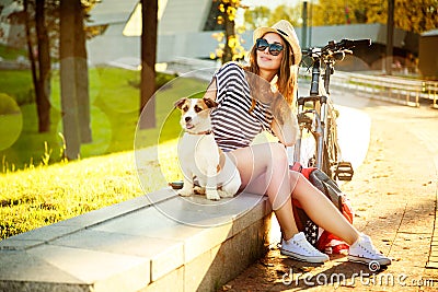 Smiling Hipster Girl with her Dog and Bike Stock Photo