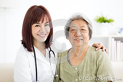 Smiling home caregiver with senior woman Stock Photo