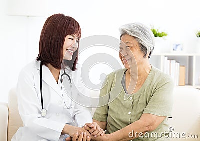 Smiling home caregiver with senior woman Stock Photo