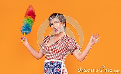 Smiling housewife hold colorful duster brush Stock Photo