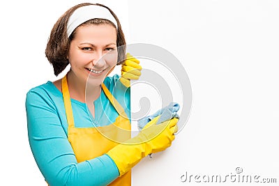 Smiling housewife holding a rag and a poster Stock Photo