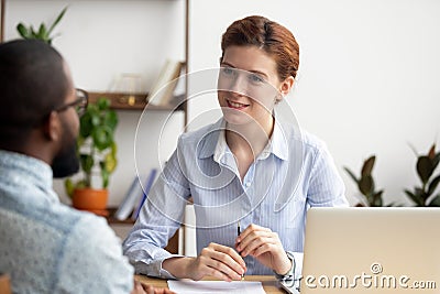 Smiling hr manager listening to african job seeker at interview Stock Photo