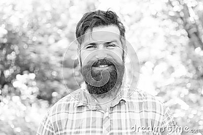 Smiling increases happiness. Bearded man with cheerful smiling face on natural landscape. Smiling hipster wearing Stock Photo