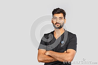 Smiling indian doctor or surgeon in black uniform with stethoscope on gray background Stock Photo