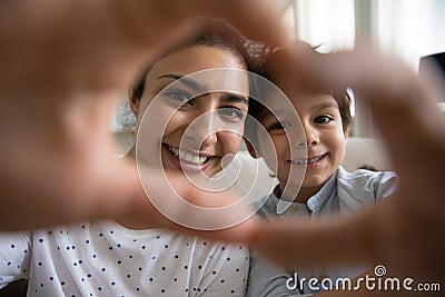 Smiling Indian mother and 5s son showing heart gesture Stock Photo