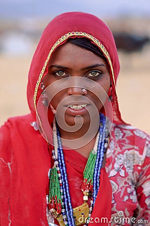 A smiling indian woman dressed in traditional Rajasthani clothing at Pushkar Camel Fair, North Western India Editorial Stock Photo