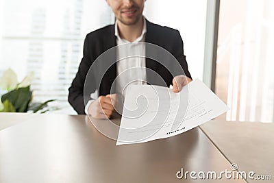 Smiling job applicant handing over resume to recruiter during in Stock Photo