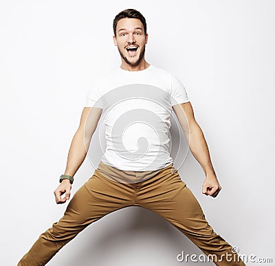 Smiling joyful man jumping on a white background. Stock Photo