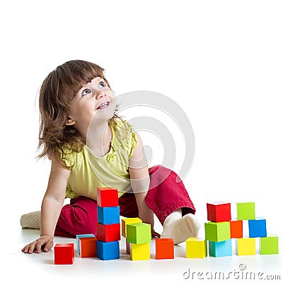 Smiling kid girl playing building cubes toys Stock Photo