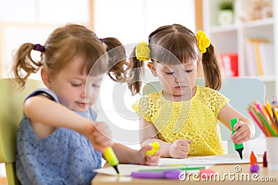 Smiling kids drawing together at hobby group indoors Stock Photo