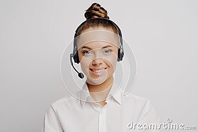 Female call center worker in white shirt smiling at camera Stock Photo