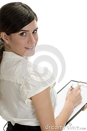 Smiling lady with pen and paper in writing pad Stock Photo