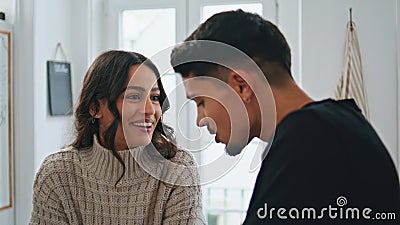 Smiling lady speaking to husband at home closeup. Tender man feeding woman Stock Photo