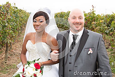 happy newlywed ethnic black African American woman and mid aged blad Caucasian man Stock Photo