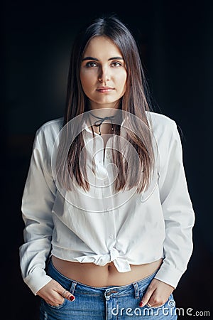 Smiling laughing white Caucasian brunette young beautiful girl woman model with long dark hair and brown eyes in white shirt Stock Photo