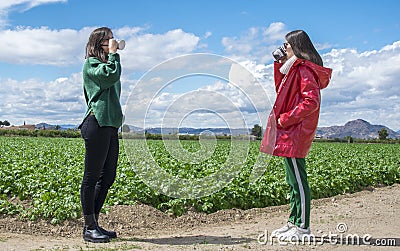 Smiling laughing young women having fun while drinking coffee and chatting outdoor. People, communication and friendship Editorial Stock Photo