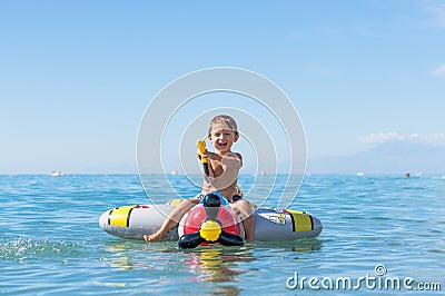 Smiling little baby boy playing in the sea on the air plane. Positive human emotions, feelings, Stock Photo