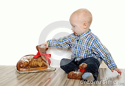 Two years old little boy want to eat Easter lambs Stock Photo