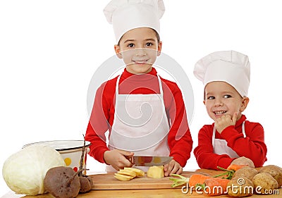 Smiling little chief-cookers on the desk Stock Photo