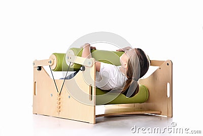 Smiling little child demonstrating usage of exercise set for persons with locomotor disorder, isolated on white, copy space Stock Photo