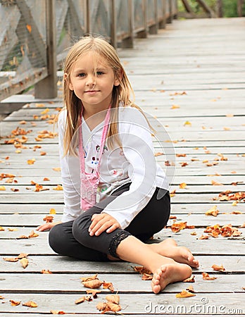 Smiling little girl on bridge Stock Photo