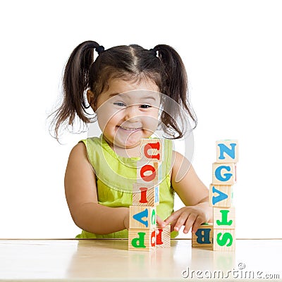 Smiling little girl is building a toy block Stock Photo