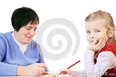 Smiling little girl and happy mature woman draws Stock Photo