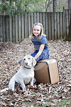 Smiling little girl outdoors with white dog Stock Photo