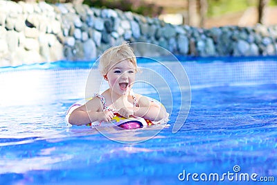 Smiling little girl in swimming pool Stock Photo