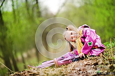 Smiling little girl with umbrella in the park Stock Photo