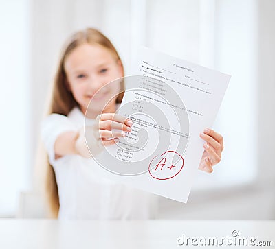 Smiling little student girl with test and A grade Stock Photo