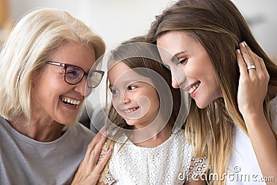 Happy senior grandma embracing kid granddaughter and daughter ha Stock Photo